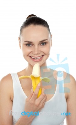 Young lady eating banana Stock Photo