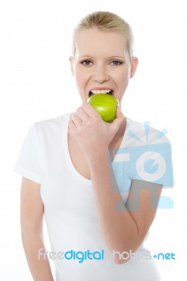 Young Lady Eating Green Apple Stock Photo