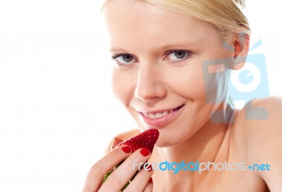 Young Lady Holding A Strawberry Stock Photo