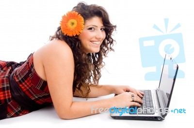 Young Laying Model Working On Laptop Stock Photo