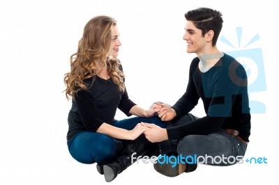 Young Loving Couple On Floor Holding Hands Stock Photo