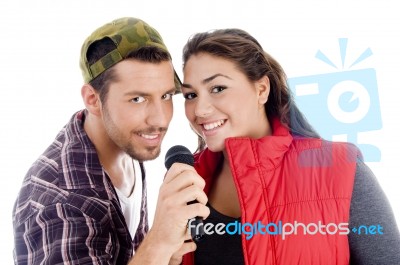 Young Male And Female Singer With Microphone Stock Photo