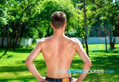 Young Male Athlete Demonstrates His Back Muscles Stock Photo