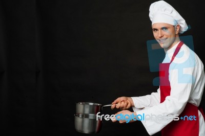 Young Male Chef Holding Empty Vessels Stock Photo