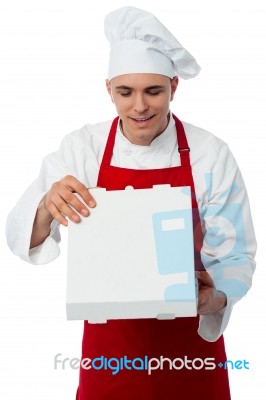 Young Male Chef Holding Pizza Box Stock Photo