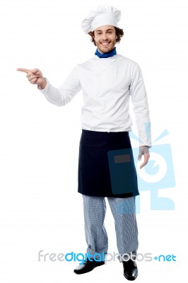 Young Male Chef Pointing To A Product Stock Photo