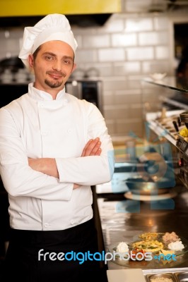 Young Male Chef Posing With Confidence Stock Photo