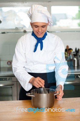 Young Male Chef With Whisk And Mixing Bowl Stock Photo