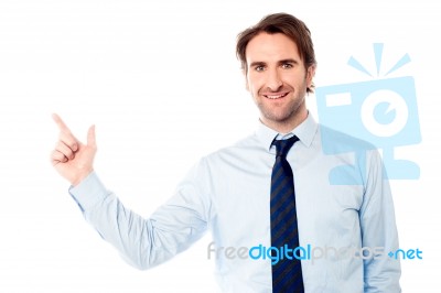 Young Male Executive Pointing Away Stock Photo