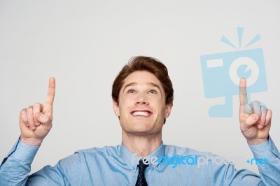 Young Male Executive Pointing Up Stock Photo