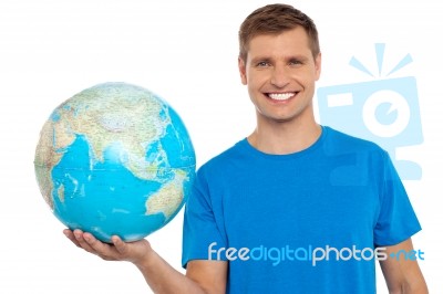 Young Male Holding Globe Stock Photo