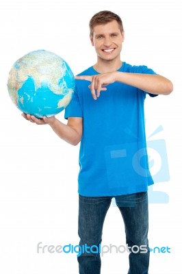 Young Male Holding Globe Stock Photo