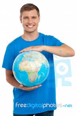 Young Male Holding Globe Stock Photo