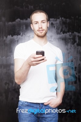 Young Male Holding Smartphone Stock Photo