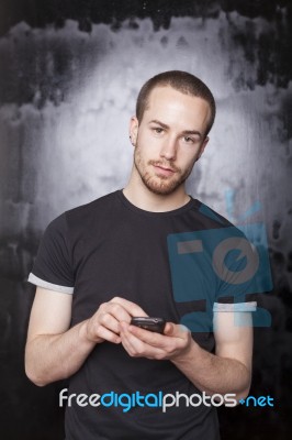 Young male holding smartphone Stock Photo