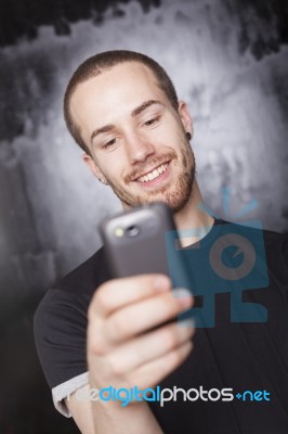 Young Male reading sms Stock Photo