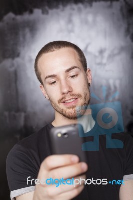 Young Male Reading Sms Stock Photo