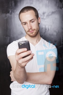 Young Male Reading Sms Stock Photo