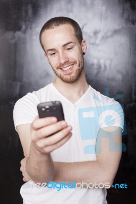 Young Male Reading Sms Stock Photo