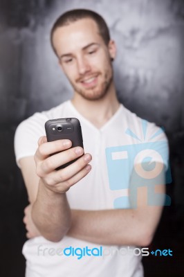 Young Male Reading Sms Stock Photo