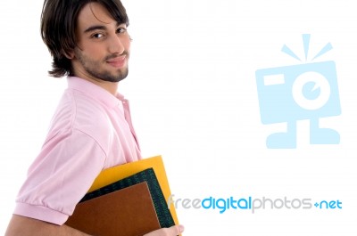 Young male Student Holding Books Stock Photo