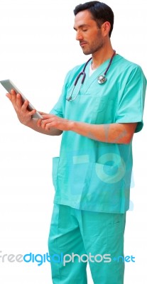 Young Male Surgeon Using Digital Tablet Stock Photo