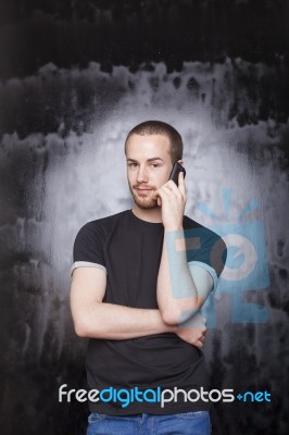 Young male talking over phone Stock Photo