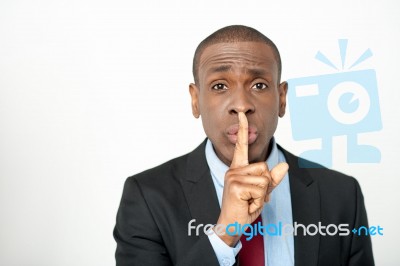 Young Male With Finger On His Lips Stock Photo