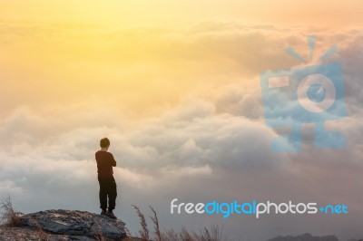 Young Man  Asia Tourist  At Mountain Is Watching Over The Misty Stock Photo