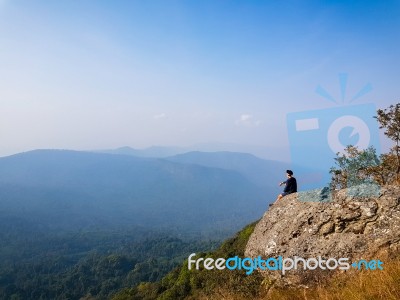 Young Man  Asia Tourist  At Mountain Is Watching Over The Misty Stock Photo