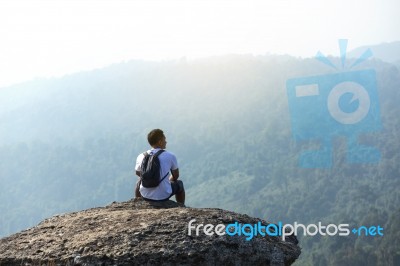 Young Man  Asia Tourist  At Mountain Is Watching Over The Misty Stock Photo