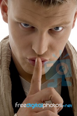 Young Man Asking To Keep Shushing Stock Photo