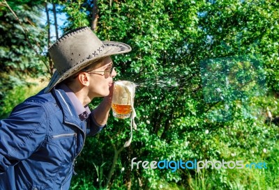 Young Man Blowing Foam From A Beer In A Mug Stock Photo