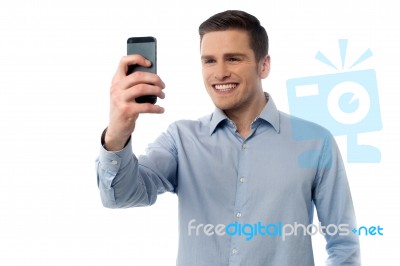 Young Man Browsing In Mobile Phone Stock Photo