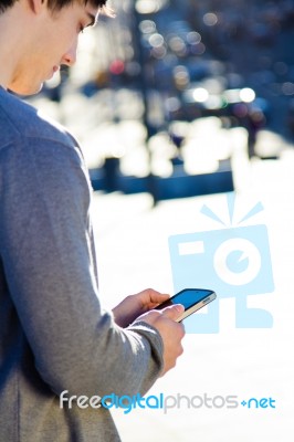 Young Man Chatting With Their Smartphone Stock Photo