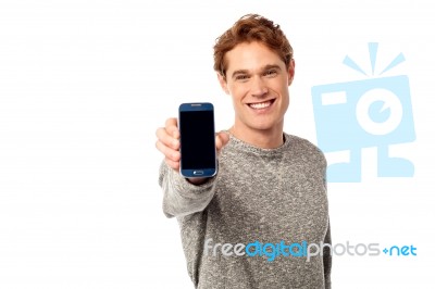 Young Man Displaying Brand New Cellphone Stock Photo