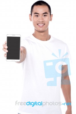 Young Man Displaying Brand New Cellphone Stock Photo