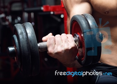 Young Man Doing Heavy Weight Exercise In Gym Stock Photo