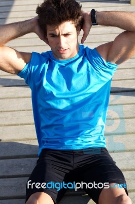 Young Man Doing Push Ups Near The Sea Stock Photo