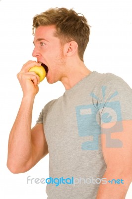 Young Man eating An Apple Stock Photo