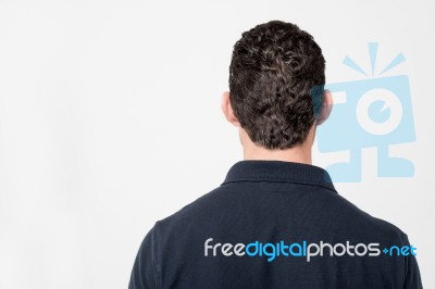 Young Man Facing The Wall Stock Photo