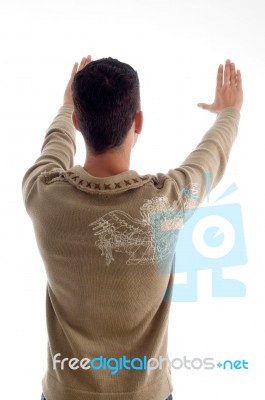 Young Man Framing Something And Posing From Back Stock Photo