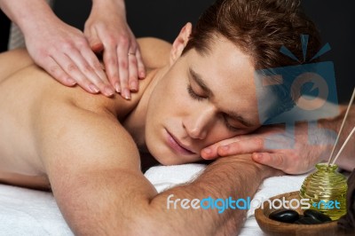 Young Man Getting Spa Massage Stock Photo