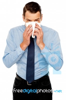 Young Man Having Severe Cold. Sneezing Stock Photo