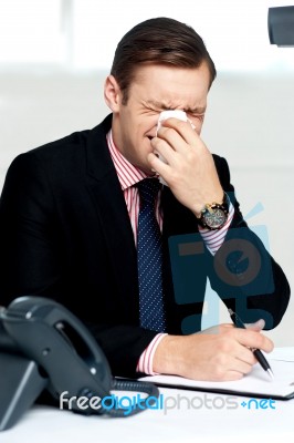 Young Man Having Severe Cold. Sneezing Stock Photo