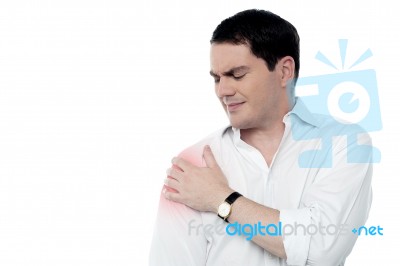 Young Man Having Shoulder Joint Pain Stock Photo