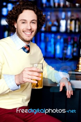 Young Man Holding A Glass Of Beer Stock Photo