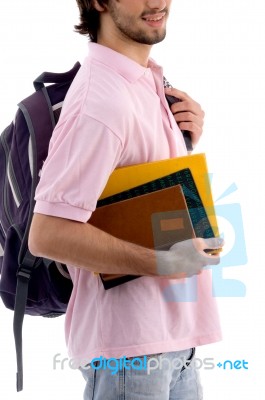 Young Man Holding Bag And Books Stock Photo