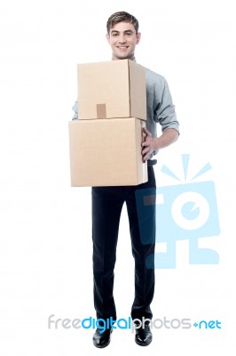 Young Man Holding Cardboard Boxes Stock Photo