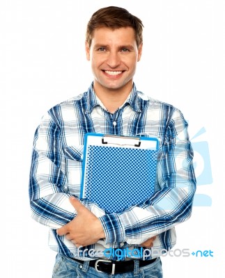 Young Man Holding Clipboard Stock Photo